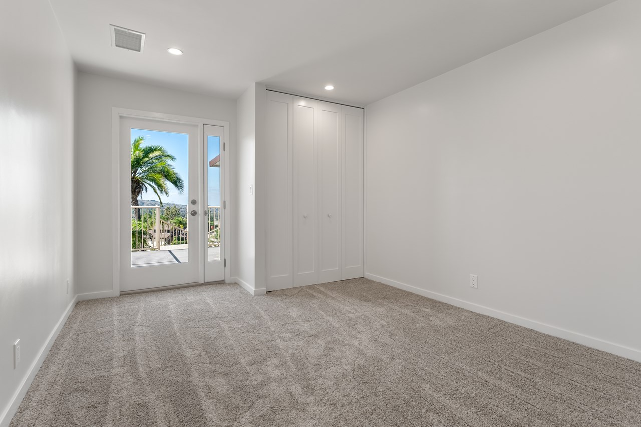 the first guest room enjoys stunning views and shares a balcony with the primary office.