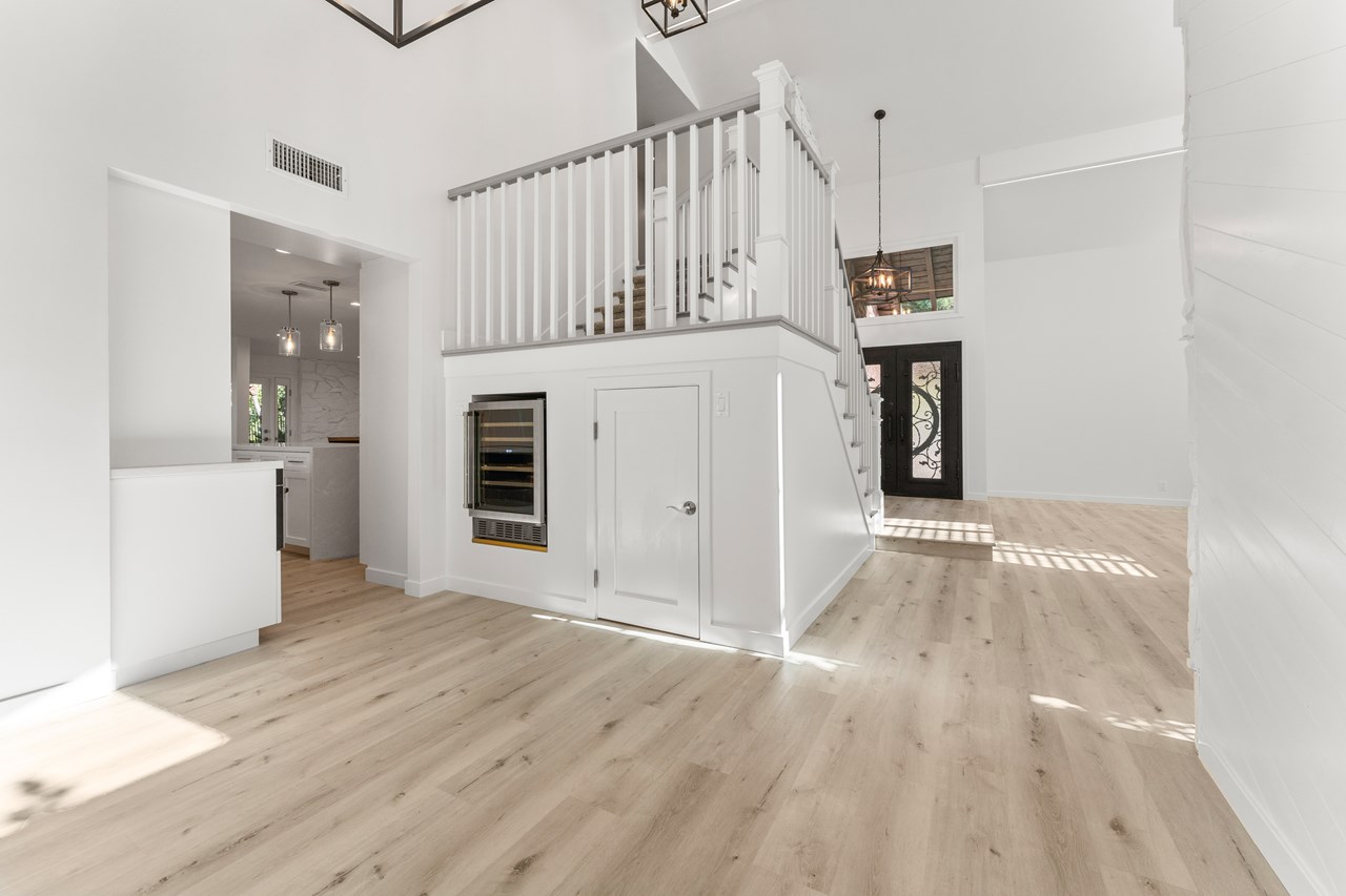 the wine fridge is located in the dining room for ease of access. the area under the stairs has been turned into a large storage area to insure there is no wasted space.