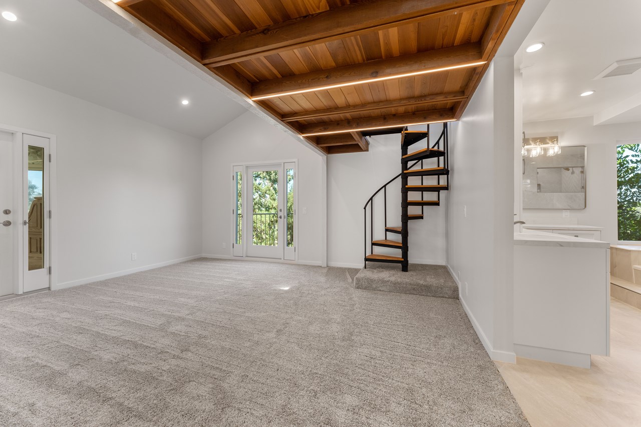 the primary bedroom is two stories. it features an office, upstairs sitting room, a private balcony, a shared balcony, a spa-like bathroom, and walk-in closet.